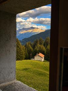 a view from a window of a field with a mountain at Casa Vista Adula, Unplug everything, breathe in Anvéuda
