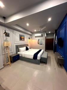 a bedroom with a large bed and a blue wall at Seashell Legacy Hotel in Karachi