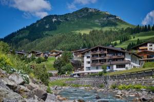 a village with a river and a mountain at Haldenhof in Lech am Arlberg