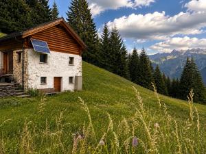 a house with a solar panel on the side of a hill at Casa Vista Adula, Unplug everything, breathe in Anvéuda