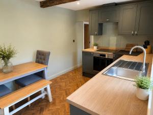 a kitchen with a sink and a counter top at The Ainsty in Thorp Arch