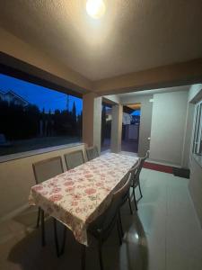 a dining room with a table and chairs and a window at Casa Daria Oradea in Oradea