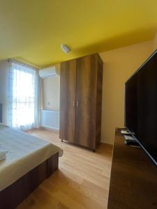 a bedroom with a bed and a flat screen tv at Casa Daria Oradea in Oradea