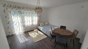 a bedroom with a table and a bed and a table and chairs at Villa Ruscello in Grabovac +15 photos
