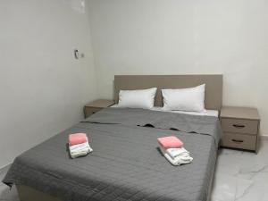 a bedroom with a bed with two pillows on it at Midtown Appart Hôtel in Nouadhibou