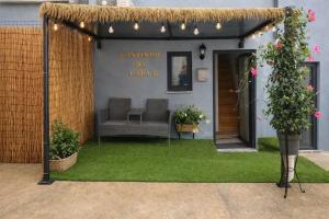 a gazebo with a couch in a yard at Cantinho Da Lapa in Porto