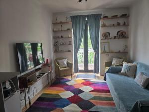 a living room with a couch and a tv at Mery in Craiova