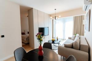 a living room with a couch and a table at Vrtovi Boke by Montena in Dobrota