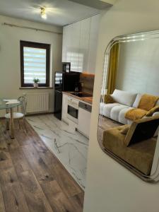 a living room with a couch and a table at Apartament przy Matce Polce in Łódź