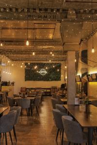 a dining room with tables and chairs and lights at Hotel Vinnica in Wieliczka
