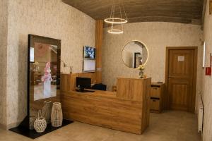 a dressing room with a mirror and a desk at Hotel Vinnica in Wieliczka