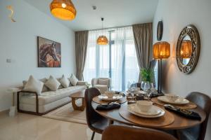 a living room with a table and a couch at Pearl 1BR Al Reem - Serene Luxe Escape in Abu Dhabi
