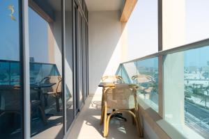 a balcony with chairs and tables on a building at Pearl 1BR Al Reem - Serene Luxe Escape in Abu Dhabi