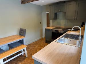 a kitchen with a sink and a counter top at The Ainsty in Thorp Arch