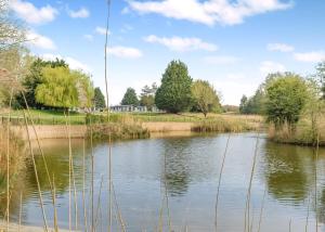 a view of a river with trees in the background at Faringdon Grange in Faringdon