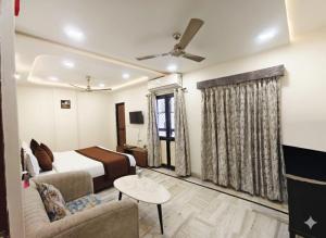 a hotel room with a bed and a couch at Holiday Out hotel in Jodhpur