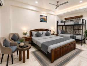 a bedroom with a bed and a couch and a chair at Holiday Out hotel in Jodhpur