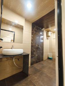 a bathroom with a sink and a mirror at Holiday Out hotel in Jodhpur