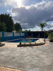 a courtyard with a pool and a cloudy sky at L'Hotelet del Delta - adults in Deltebre