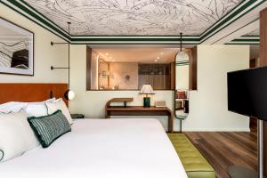 a hotel room with a bed and a desk at Kimpton Quinta da Marinha by IHG in Cascais
