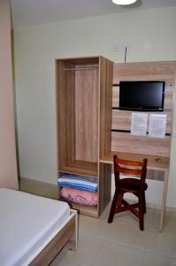 a bedroom with a bed and a desk and a chair at Hotel Maranhão in Ourinhos