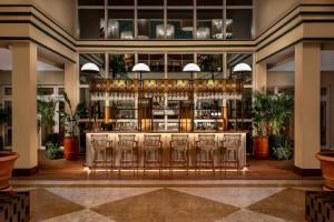 a bar in a hotel lobby with chairs at Kimpton Quinta da Marinha by IHG in Cascais +124 photos