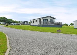 a gravel road with houses in the background at Lillyhall Lodge Retreat in Workington