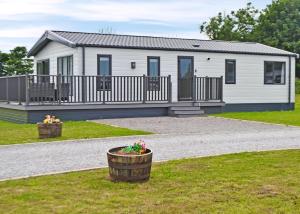 a large white house with a porch and a yard at Lillyhall Lodge Retreat in Workington