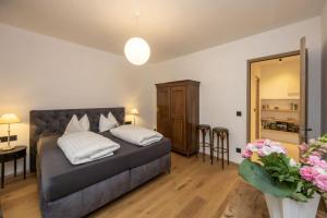 a bedroom with a bed and a table and chairs at Suite Lazzeri in Cortaccia