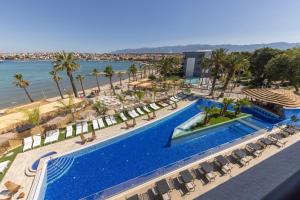an aerial view of a resort pool and the beach at Liberty S Hotel in Novalja