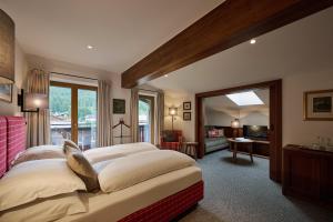 a bedroom with two beds and a living room at Haldenhof in Lech am Arlberg +47 photos