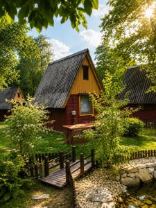 a wooden cabin with a fence in front of it at Kemp Sluníčko in Doksy