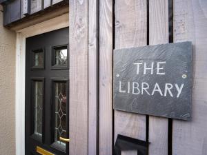 a sign for the library on the side of a building at North Star Apartment - Uk3446 in Greenhaugh