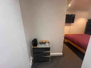 a room with a bedroom with a bed and a table at Home from Home 1 in Castleford