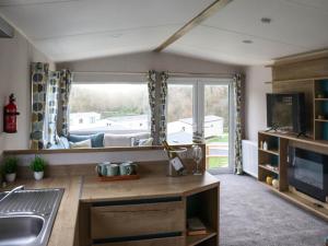 a kitchen with a sink and a large window at Birch 3 - Ukc8216 in Pendine