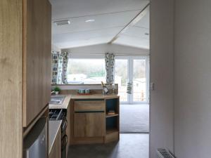 a kitchen with a sink and a stove at Birch 3 - Ukc8216 in Pendine +2 photos