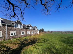a row of houses on a grassy field at Bramling Apartment - Uk49302 in Woolfardisworthy +16 photos