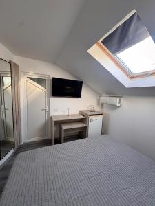 a bedroom with a bed and a skylight at Casa Silvia in Eforie Nord
