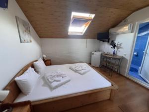 a bedroom with a bed with two towels on it at Casa Silvia in Eforie Nord +19 photos