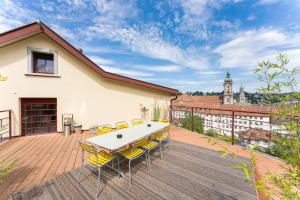 a patio with a table and chairs on a deck at TouchBed in St. Gallen