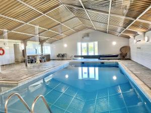 a large swimming pool in a house with a ceiling at Chestnut Apartment - Uk49277 in Woolfardisworthy +16 photos