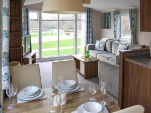 a dining room and living room with a table and chairs at Birch 1 - Ukc8214 in Pendine