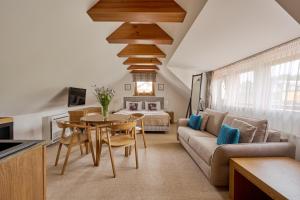 a living room with a couch and a table at Palanga Visit Apartments and SPA in Palanga