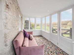 a living room with a couch and windows at Mill House - Uk50646 in Falmouth