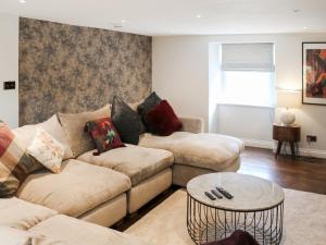 a living room with two couches and a table at Mill House - Uk50646 in Falmouth +12 photos