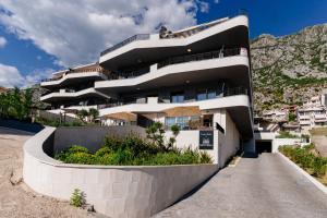 a building on the side of a mountain at Vrtovi Boke by Montena in Dobrota