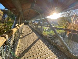 a bridge with the sun shining on the horizon at Les Variétés in La-Roche-en-Ardenne +18 photos