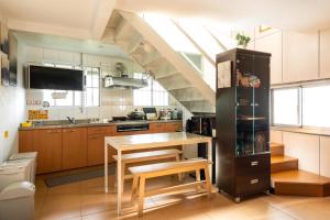 a large kitchen with a table and a staircase at 歐森View包棟Villa x 雲海夜景 x 獨立空間 in Dongshi +27 photos
