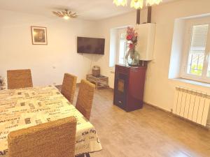 a dining room with a table and a television at San Millán 1 in Soria