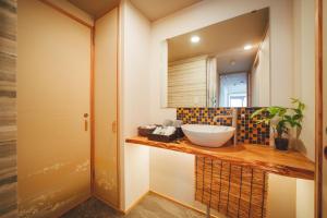 a bathroom with a sink and a mirror at ヒカリとテラス in Nagano +13 photos